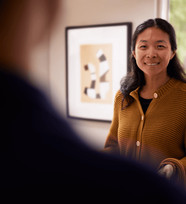 Photo showing a therapist smiling and greeting a client